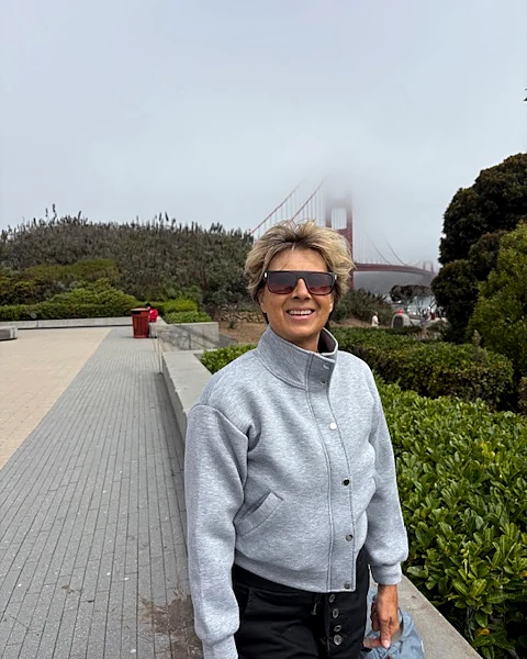 Edwina Bogush, podiatrist, smiling outdoors with the Golden Gate Bridge behind her